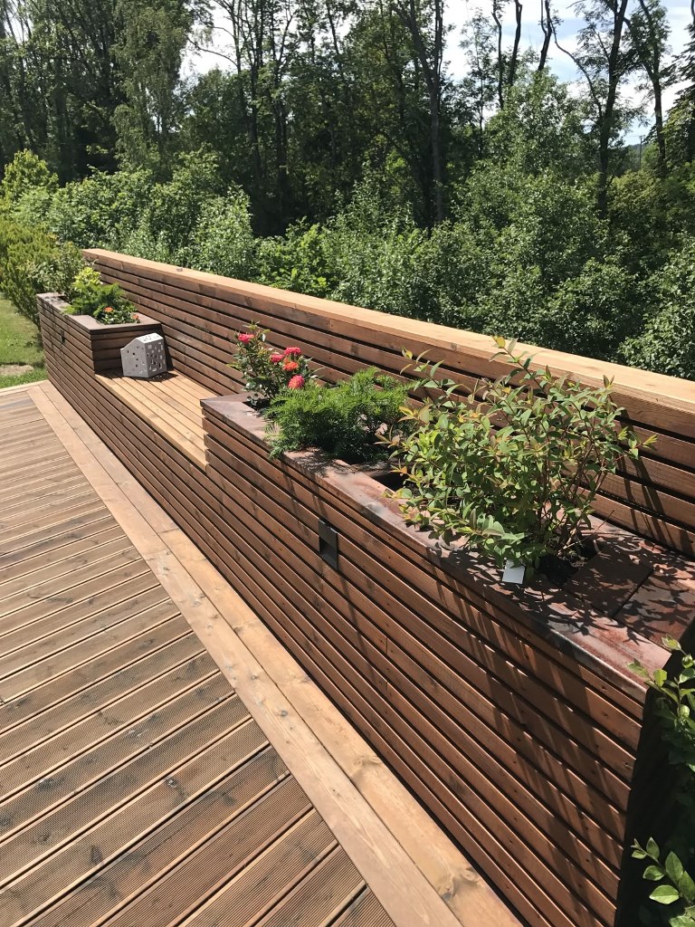This unit consists of slatted built-in planters and a bench, and it's a cool solution for a narrow deck.