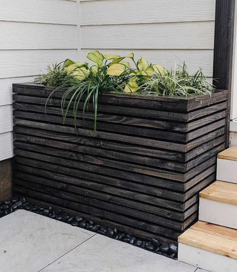 This dark-stained planter is placed in the corner next to the staircase to save the space.


(via pineandpoplar).