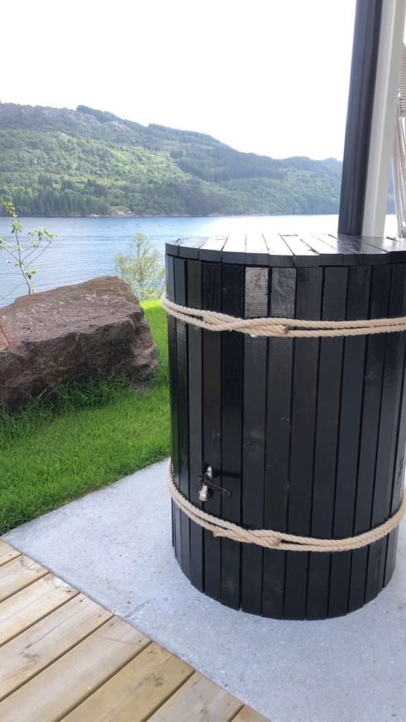 If you don't like the look of the barrel you have, cover it with wood or some other material to match the space.