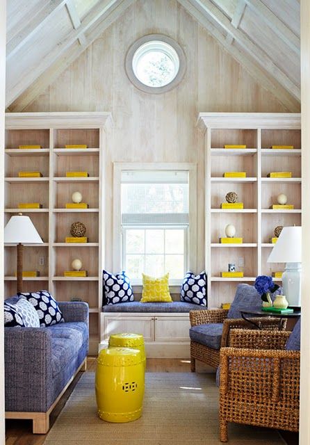 Sunny yellow accessories and pillows plus a side table make the space look super bold and bright.
