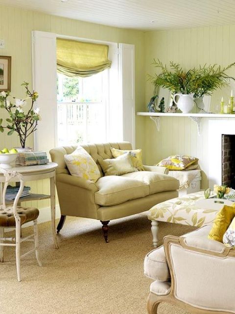 Floral print textiles, greenery and blooms in vases for a fresh summer feel in the neutral living room.