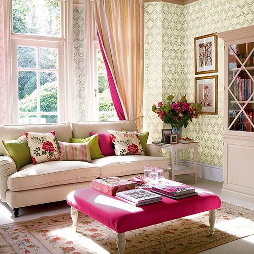 Bold and floral print pillows and an ottoman, pink striped curtains and blooms for a summer living room.