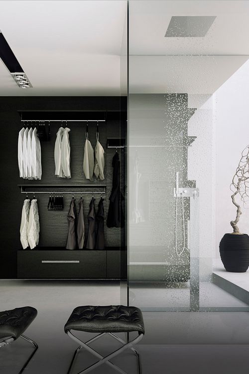 A minimalist black and white closet with a built-in shower space enclosed in glass and a rain shower is a gorgeous idea to rock.