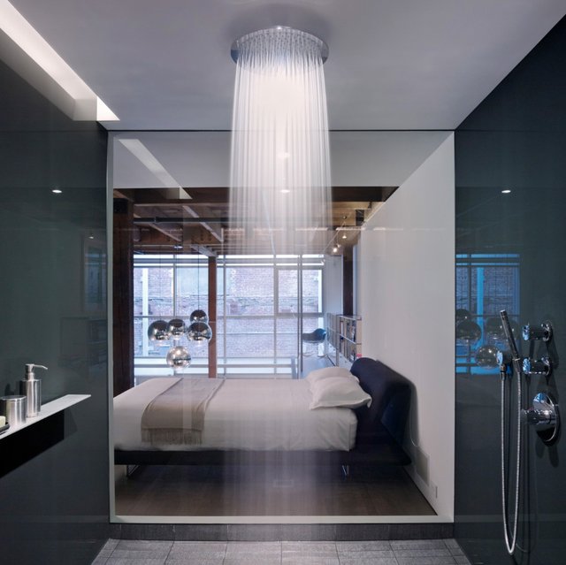 A contemporary bedroom with a glazed shower wall and a rain shower is a lovely idea for a contemporary space, and rain shower helps to relax.