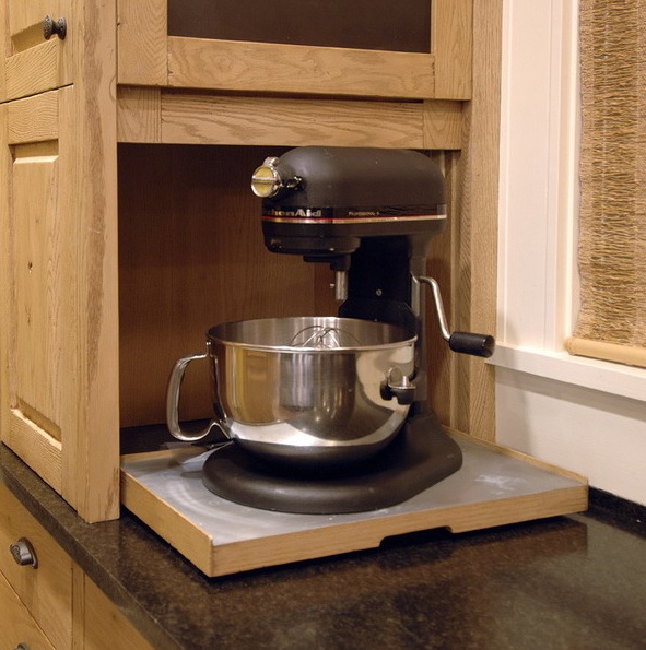A small cabinet with a retracting shelf and a mixer is a pretty idea to hide your appliance and keep the kitchen neat.