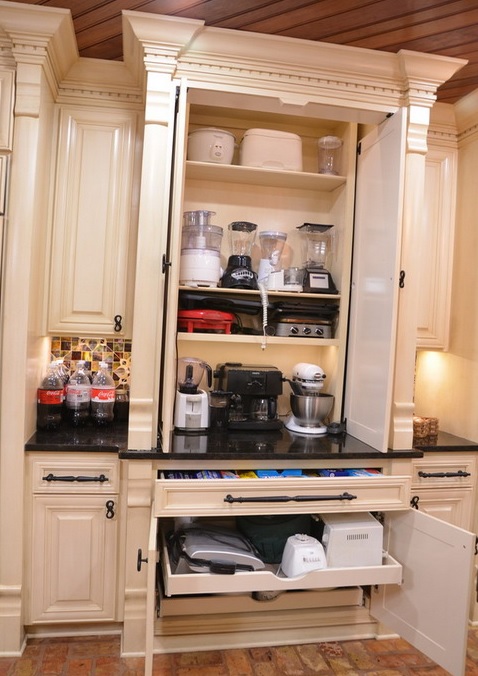 A large cabinet with shelves with appliances and drawers that hold appliances, too is a cool idea for making your kitchen more practical.