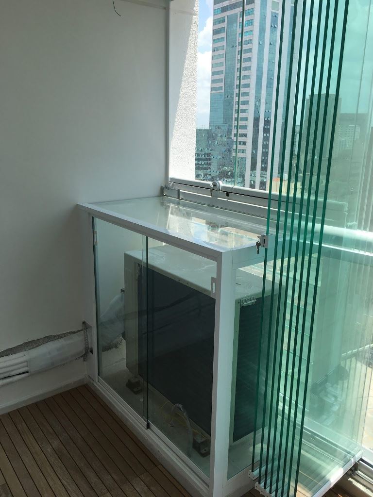 Placing an AC unit into a glass box will keep it safe and will match the contemporayr style of the space.
