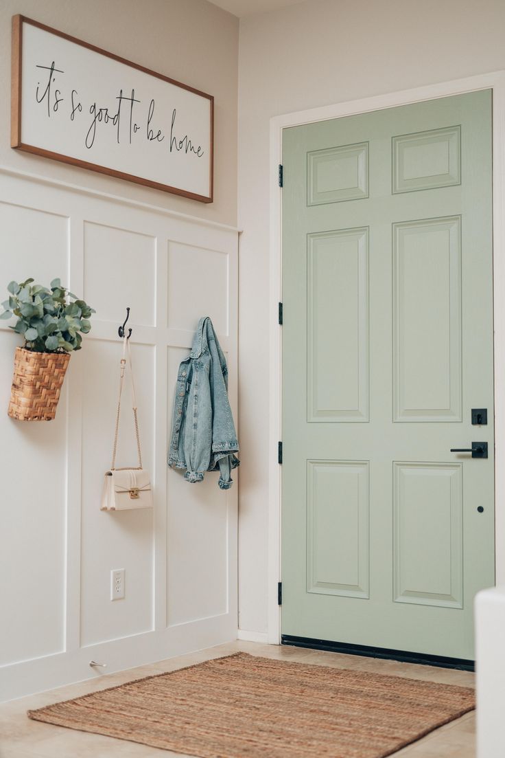 Hooks on the wall in the entryway are used for hanging clothes, bags and decor.
