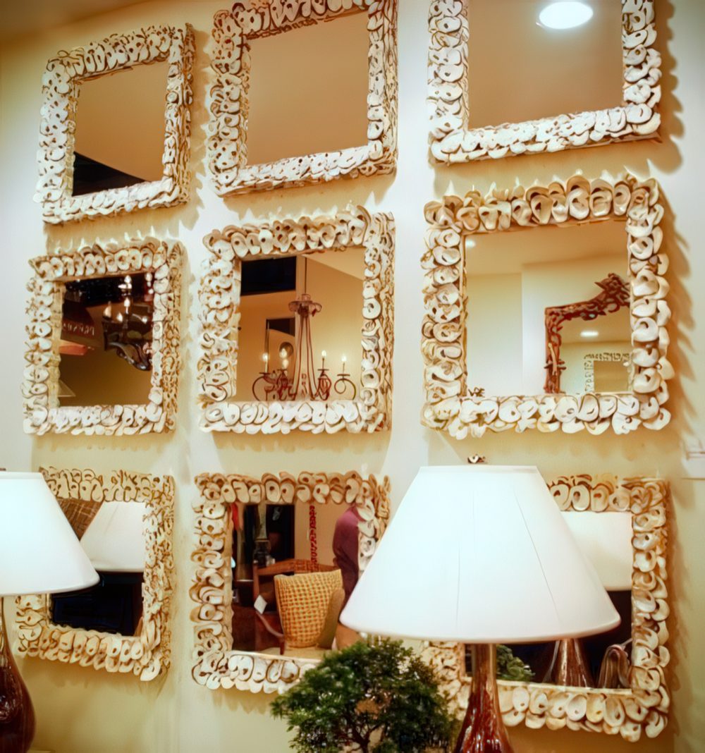 A whole gallery wall of mirrors clad with small seashells is a great idea for an entryway or some other space.