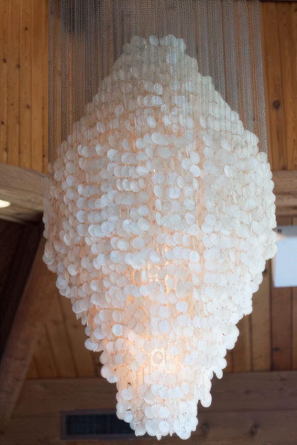 An oversized chandelier of seashells will easily turn your home into a gorgeous seaside space and it will match a boho space, too.