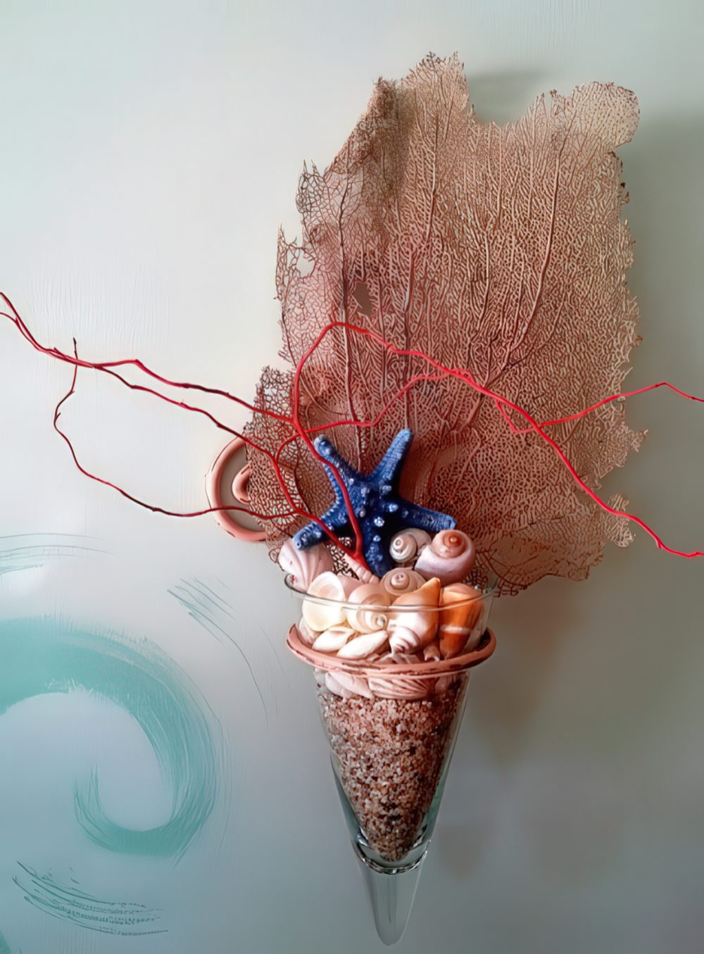 A wall decoration with seashells, starfish and a coral piece will give a slight sea feel to your space.