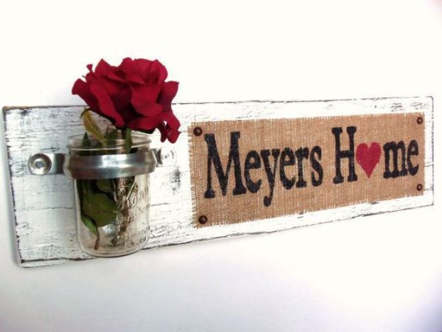 A shabby chic sign with a burlap touch, a jar with a red rose is a nice decoration for any space with a vintage or rustic feel.