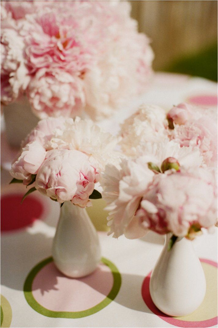 White bud vases with light pink peonies can be placed here and there as decorations, centerpieces and they will bring a cool aroma.