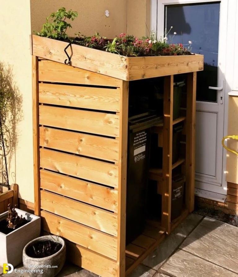 This stylish stained cover with a tray for flowers is a lovely idea for hiding eye sores.

(via engineeringdiscoveries).
