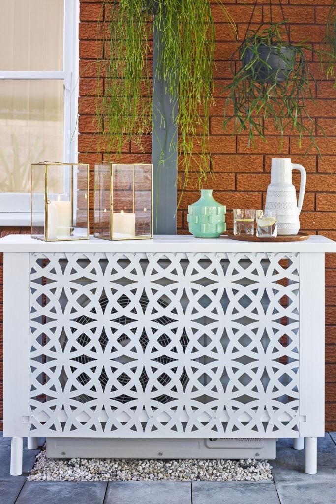 The metal screens don't only cover the AC unit but also make an outdoor console table. 


(via bhg).