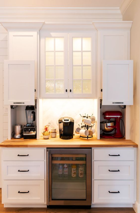 Mini cabinets with sliding doors and with appliances hidden there plus a coffee station in the center is a stylish idea.