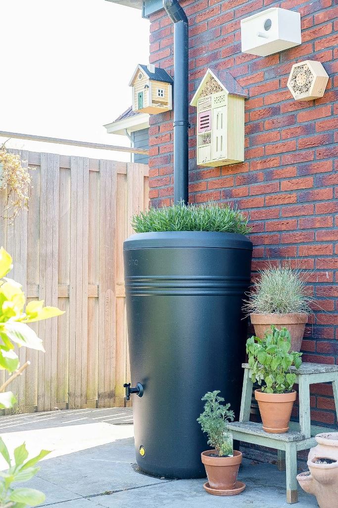 This modern black barrel is a lovely solution for a modern outdoor space, and green grass on top adds to it. 

(via sevencouches).