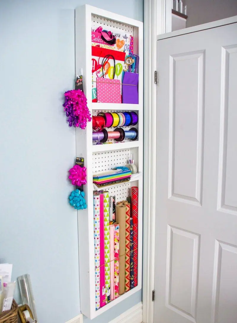 This narrow shelf is done with a pegboard and it's perfect to place some gift wrapping supplies there.