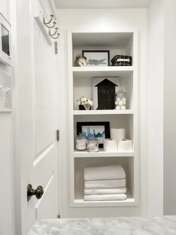 A built-in niche is always the sleekest and more comfortable solution, and if it's deep enough, it can be the only storage space in the bathroom.