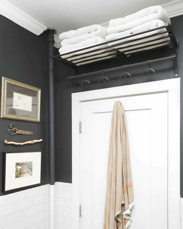This one’s a bit fancier—hooks for hanging and a shelf on top for backup towels. Great use of that weird above-door space we always forget about.