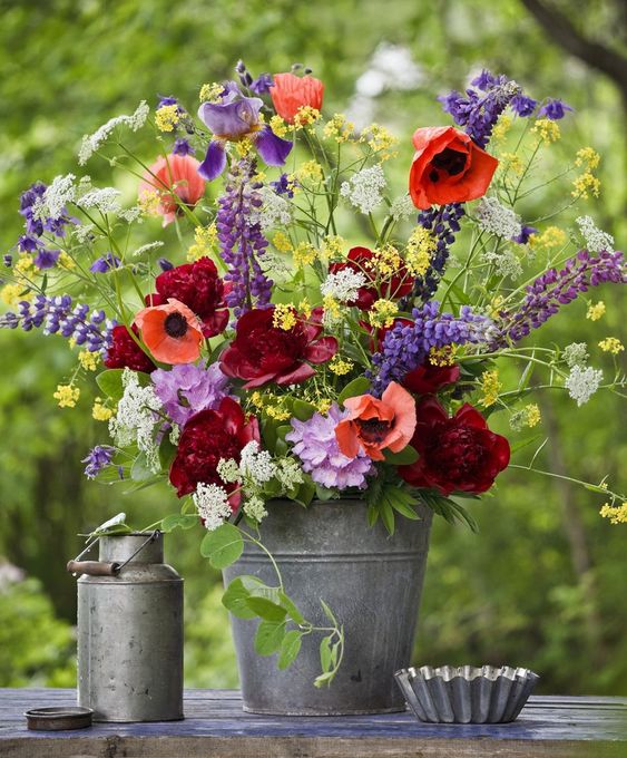 Place your colorful floral arrangement into a simple metal bucket to make your summer decor bright and fun.