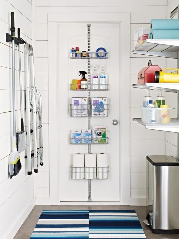 This utility room shows off several smart storage solutions: a rack on the wall, a shelving system on the door and open shelves on the opposite wall.