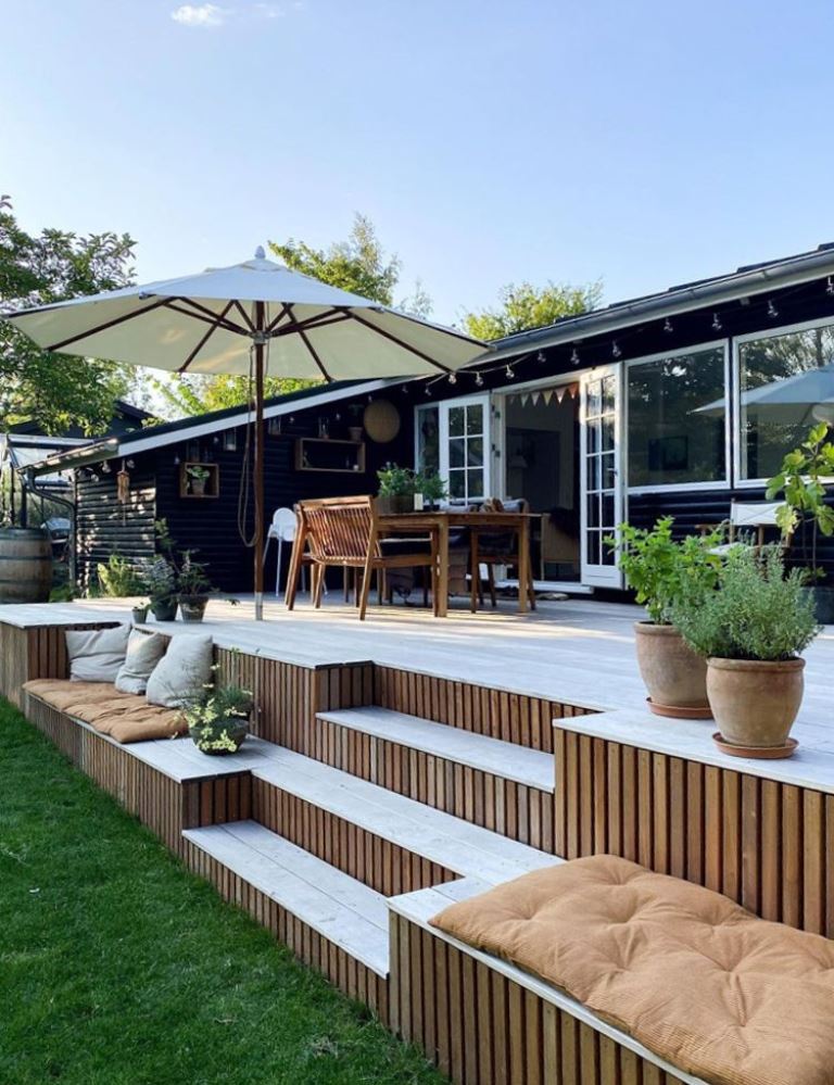 This raised deck at the house adds a dining space to it and some sets on the steps.