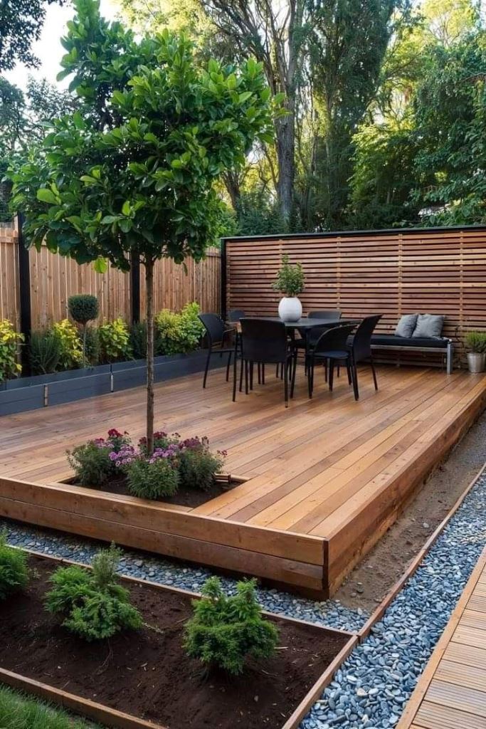 The rich-stained deck includes a living tree and some greenery along it.