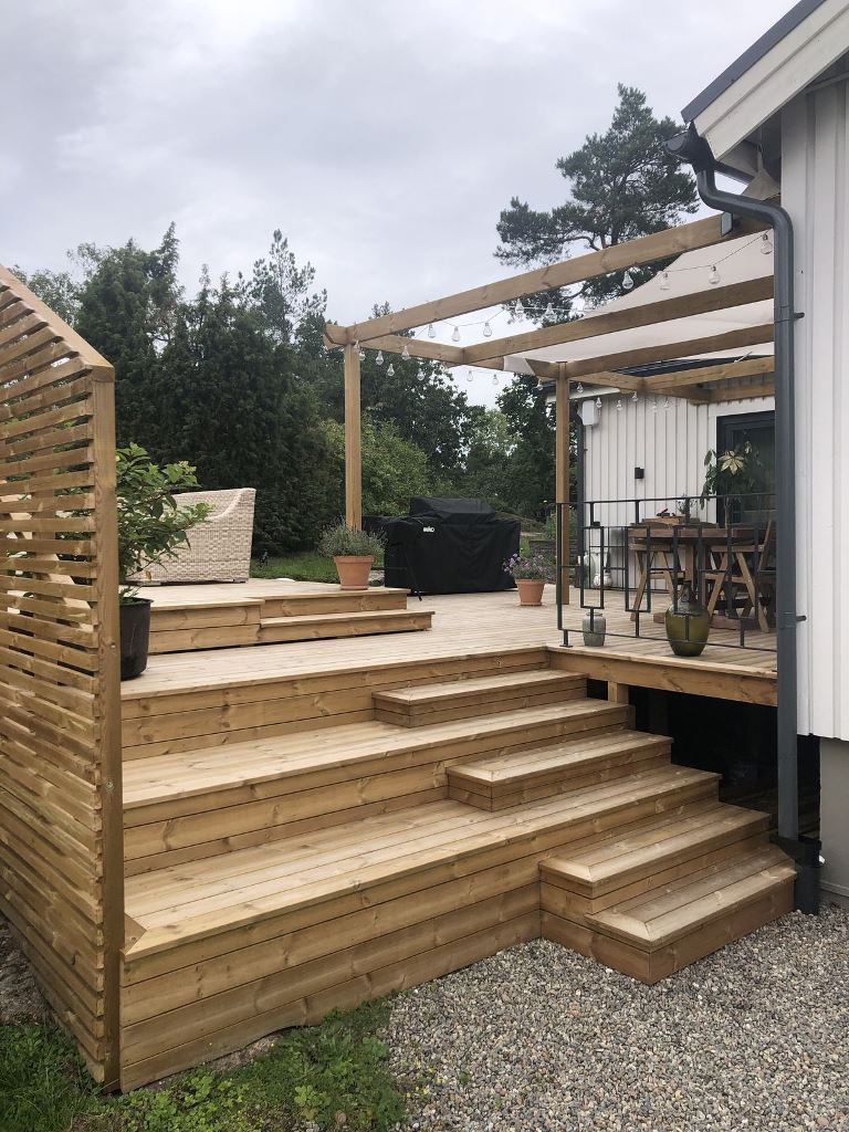 The raised deck is a living room plus dining room, with a grill and steps that can be sued for sitting, too.