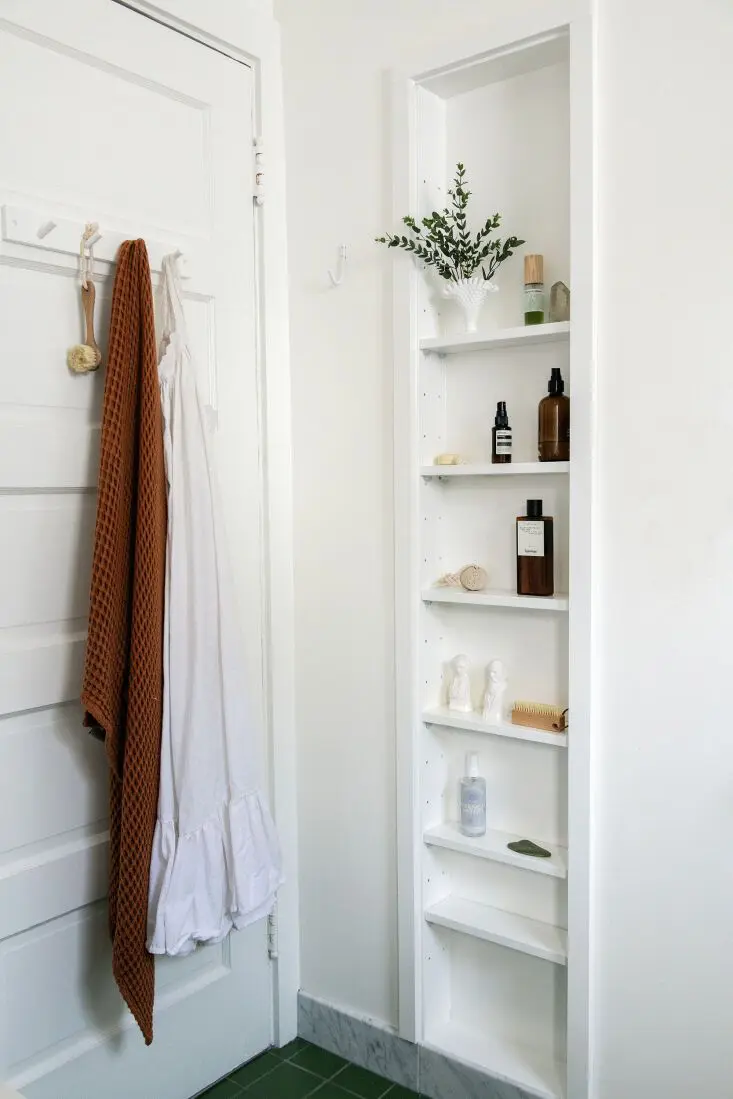 This tall, narrow and shallow wall niche is a perfect idea for a small bathroom and it looks lovely.