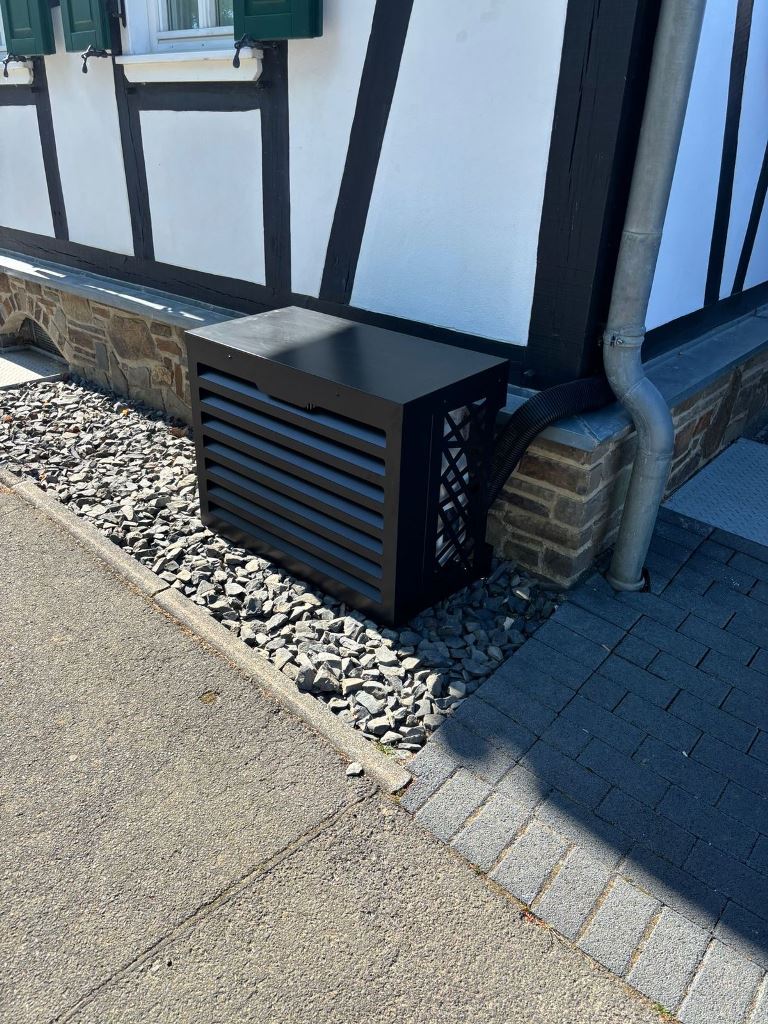 This small black metal box matches the facade and keeps the AC unit all-safe.