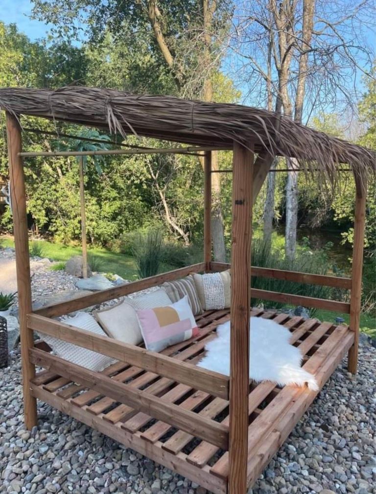 The large stained arbor is a daybed with pillows, a good idea for the pool zone.