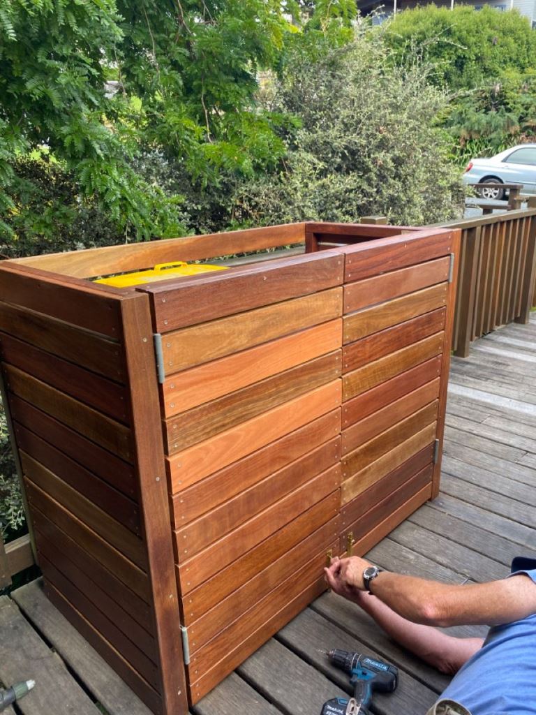 This large stained box can be DIYed to hide some trash cans.