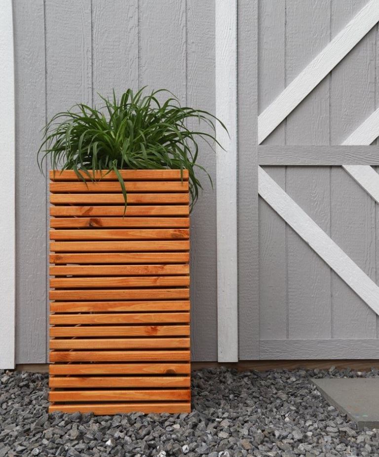 This skinny tall planter is a perfect piece to frame the front door, and any plant will look awesome in it. 

(via diyhuntress).