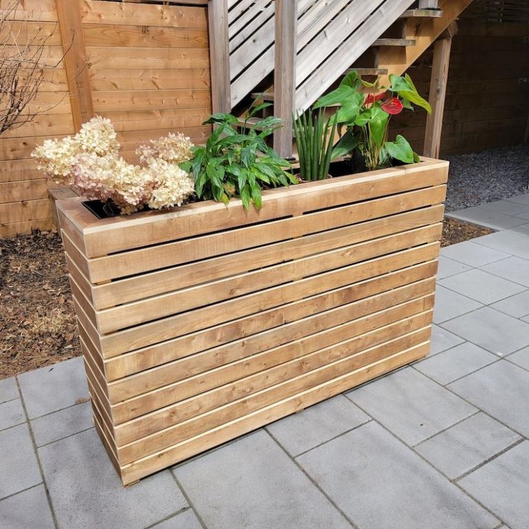 This tall skinny planter will be a nice space divider, especially if you choose tall plants.