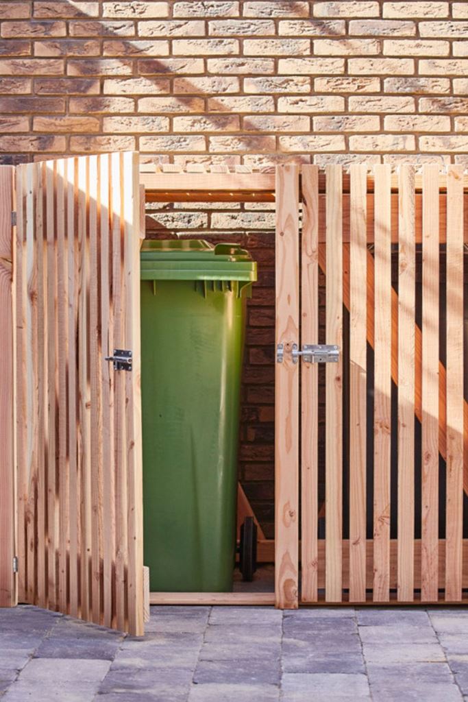 The large unit of stained slats hides all the necessary eye sores.