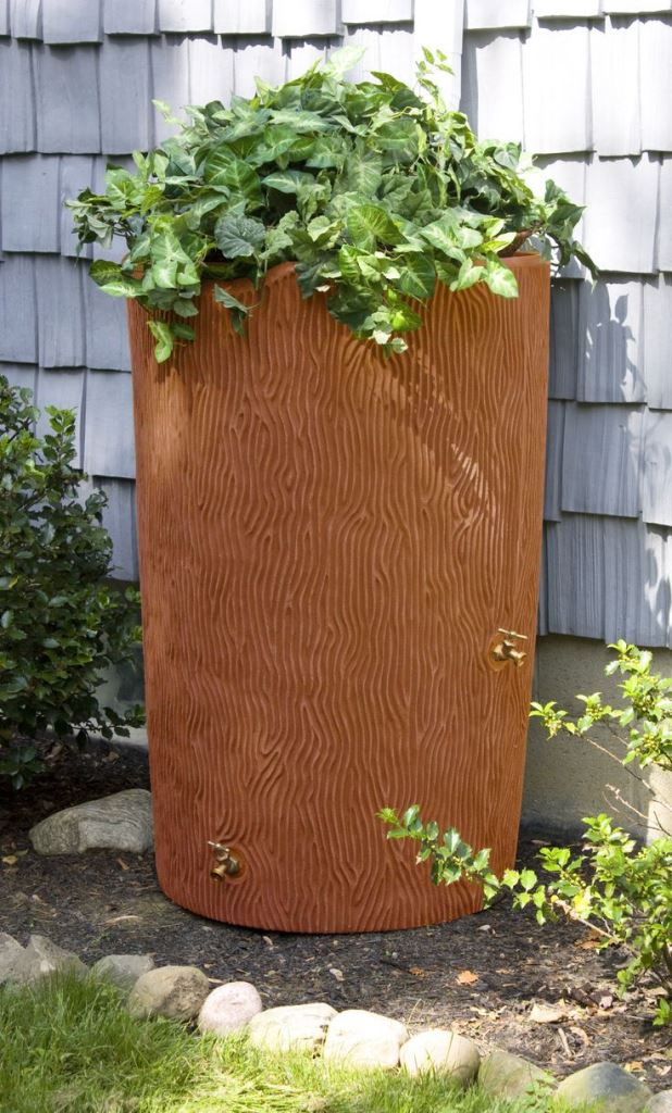 This modern textural container features greenery on top and adds style and interest to the exterior of the house.