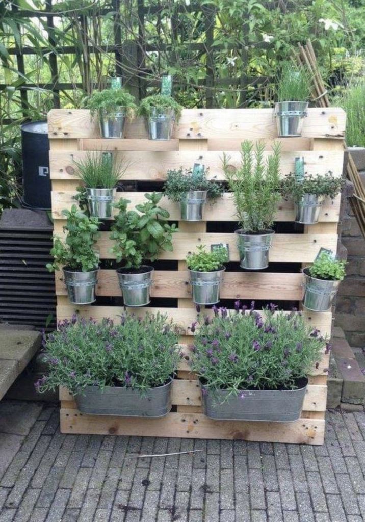 This pallet is a plant holder: there are shelves and holders for metal planters.