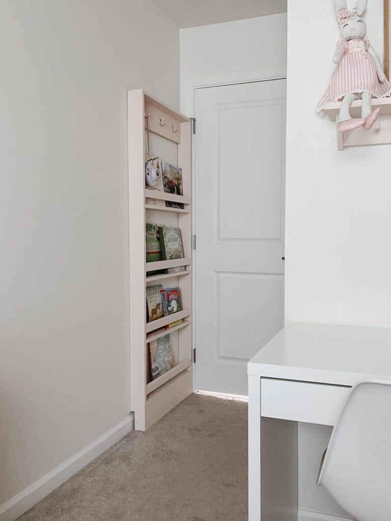 A slim shelf behind the door is always a nice solution, it can be fitted almost anywhere and matches many styles.

(via simplydiyhome).