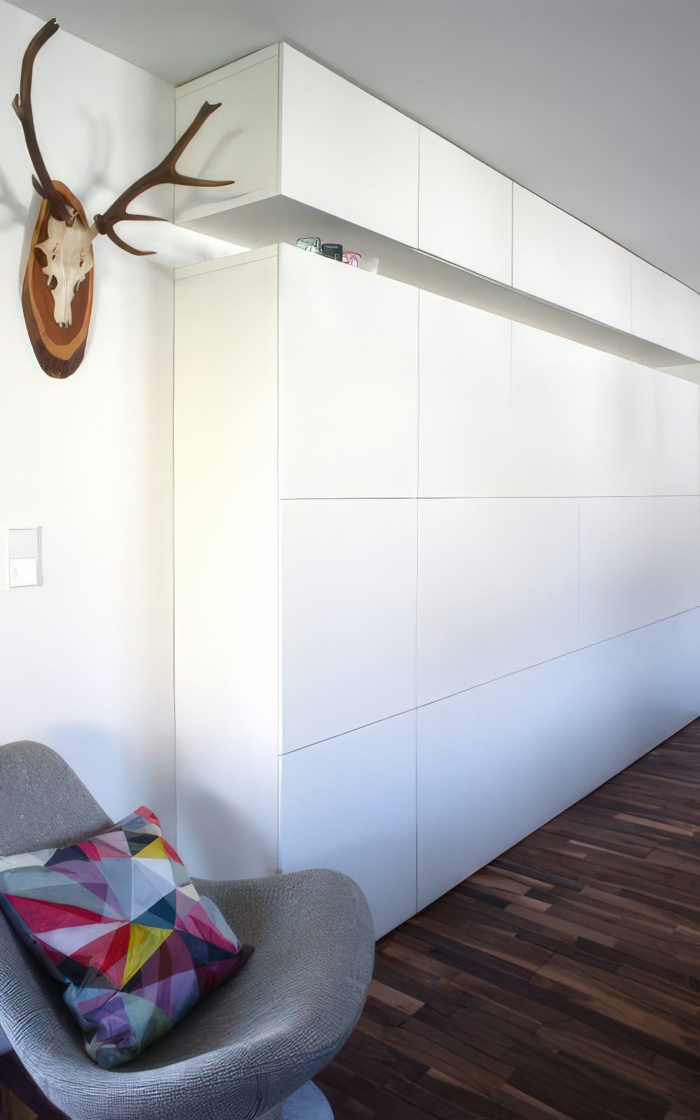 Tall white IKEA Besta storage system.