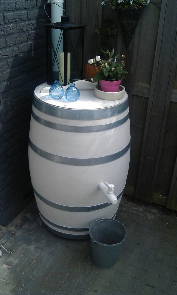 This elegant white barrel is decorated on top and it adds chic and interest to the space.