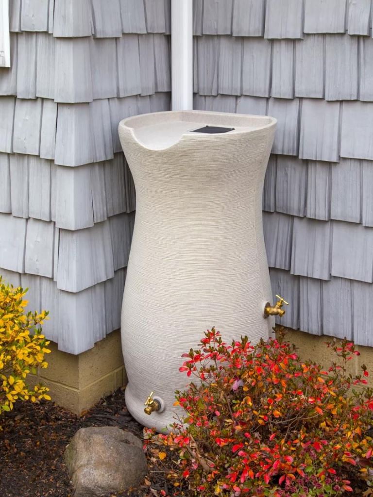 The white textural container with gold faucets is a chic and refined solution for a modern space.