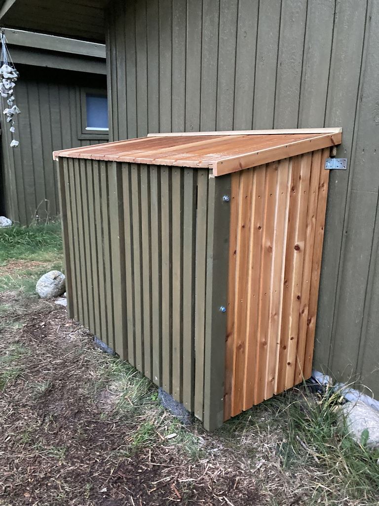 This large wooden box is stained and grey to match the facade of the house.