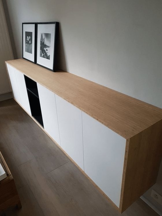 A chic contemporary floating sideboard of IKEA Metod cabinets and Tutema cabinets plus a light-colored wooden cover.