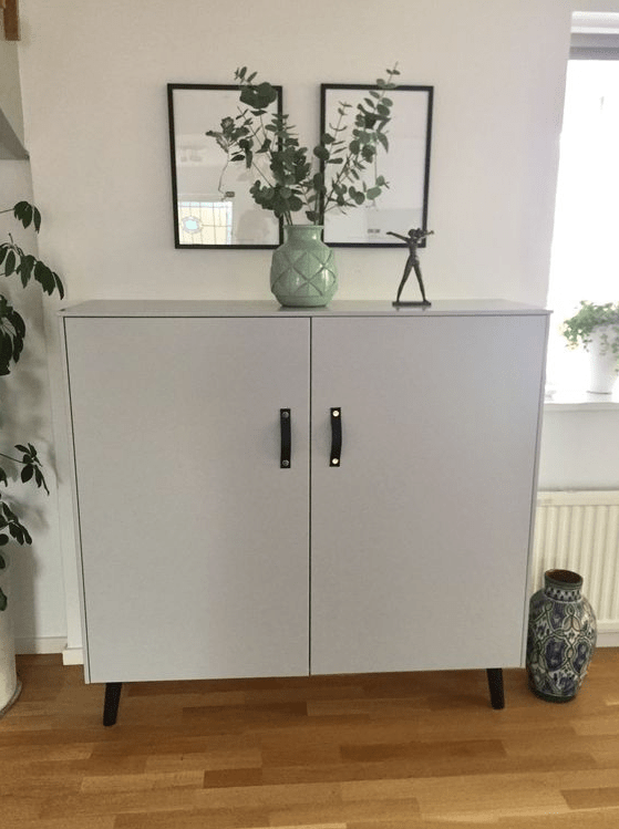 A Metod hack with grey paint, legs and leather handles gives you a Scandinanavian furniture piece.