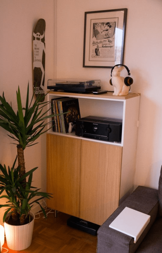 A small gaming center for a living room made from an IKEA Metod kitchen cabinets and light-stained wooden surfaces.